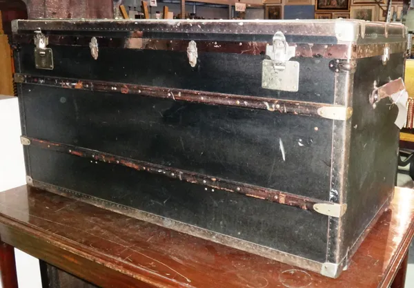 An early 20th century steamer trunk 120cm wide x 61cm high and a leather bound lift top trunk, 83cm wide x 53cm high (2).  I5
