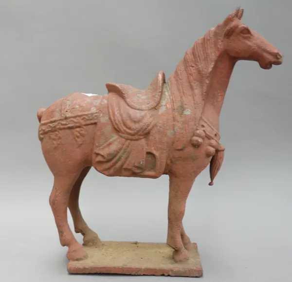 A Victorian cast iron model of a horse, later painted in a red wash, on a rectangular plinth, 40.5cm high.