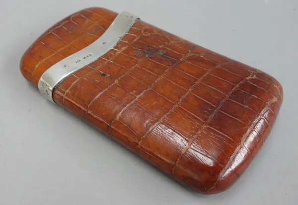 A crocodile skin cigar case with silver mounts, hallmarked London 1909, 13cm long, and a stained pine and metal mounted humidor, 50cm wide, (2).