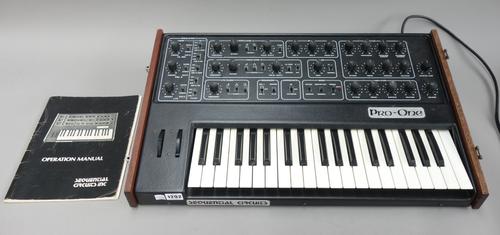 A sequential circuits 'Pro-One' synthesizer, circa 1983, J-wire, with later hardwood lid and operation manual, 65.5cm wide.