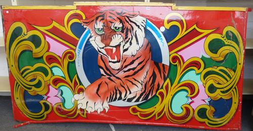 A polychrome painted wooden circus sign, depicting a tiger against a red ground, with light fitments to the rear, 230cm wide.