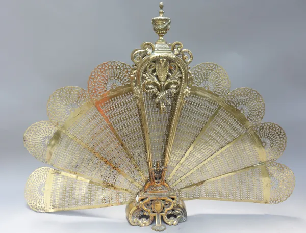 A Victorian style brass folding fire screen of pierced foliate form, 71.5cm high.