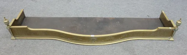 A late Victorian brass serpentine fire fender with pierced frieze and bun feet, 166cm wide and another larger brass serpentine fender with urn finials