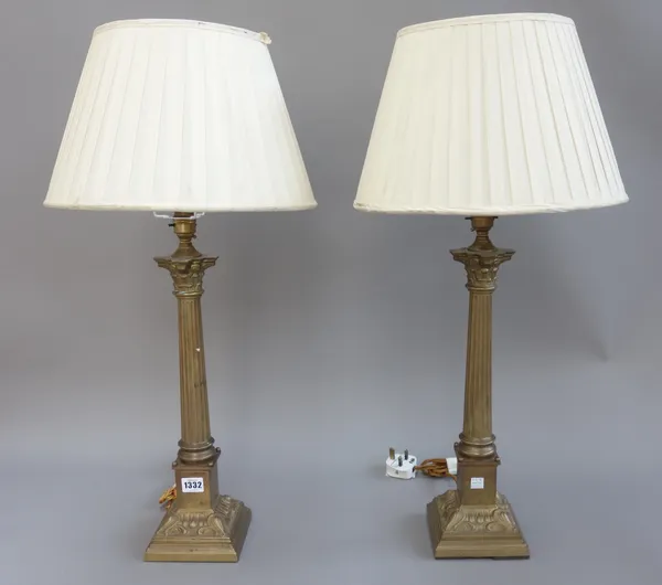 A pair of Victorian style brass table lamps, each of Corinthian column form, with cream silk pleated shades, 44cm high excluding fitments, (2).