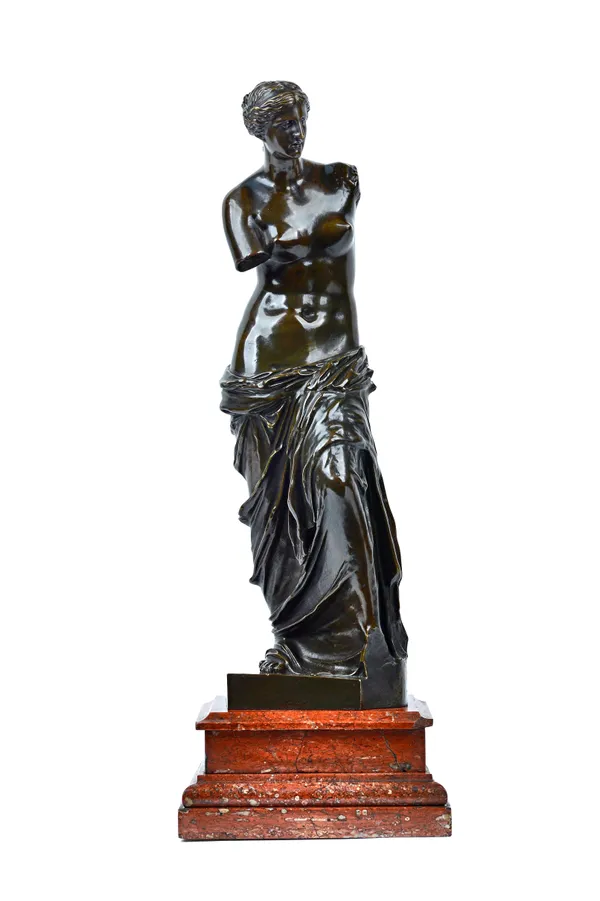 A patinated bronze 'Venus', late 19th century, mounted atop a stepped rouge rectangular base, the bronze 44cm high. Illustrated