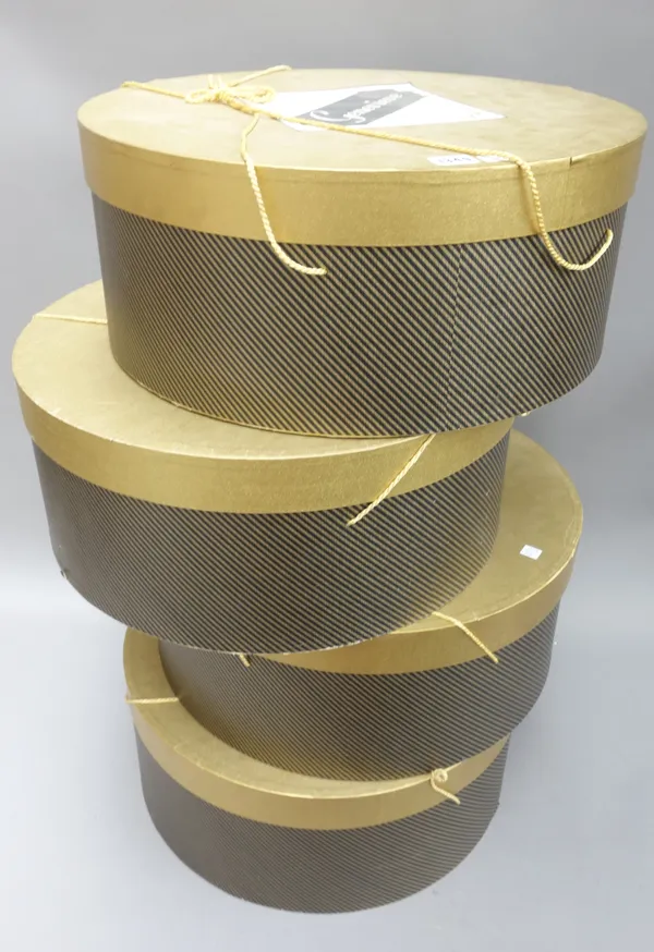 A set of four lady's hat boxes, modern, each gilt coloured with millinery paper labels and gilt cord, 50cm diameter, (4).