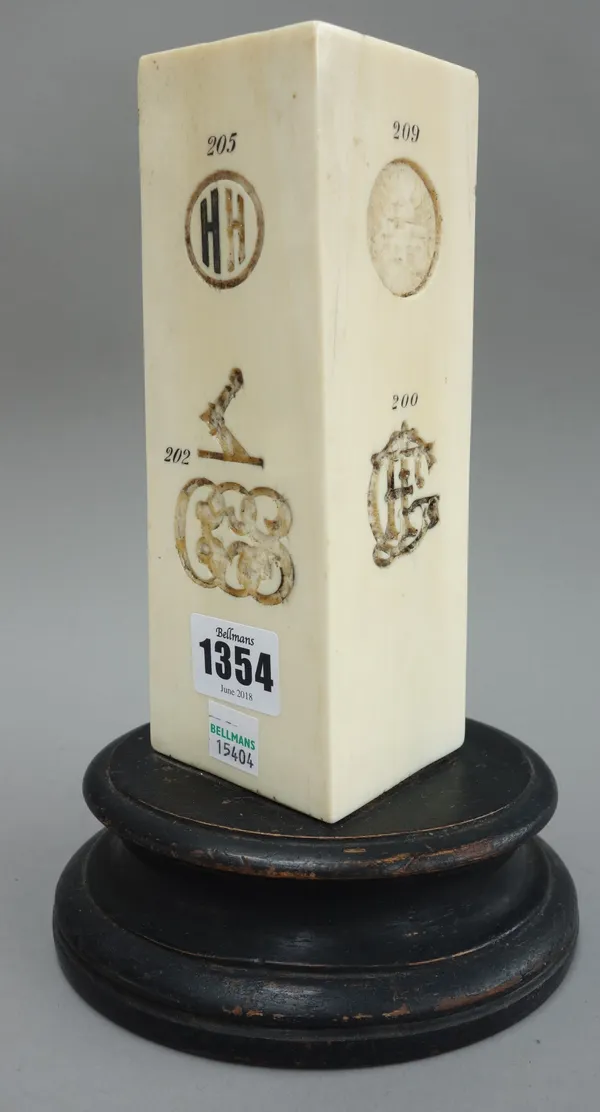 An unusual carved ivory presentation trophy, late 19th century, engraved with various numbered monograms and heraldic crests on an ebonised wooden sta