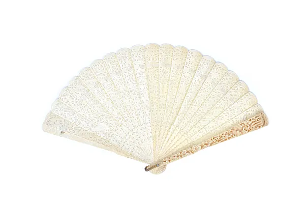 A Cantonese ivory brisé fan, circa 1900, ornately carved and pierced with figures against a landscape, the stick guard 23.5cm. Illustrated