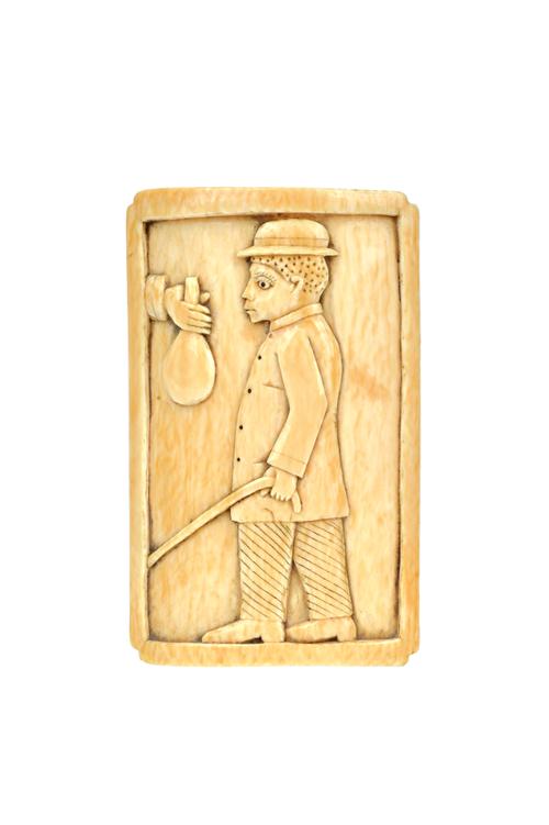 Tribal interest; an ivory paperweight, late 19th century, Loango coast, carved with a well-dressed African native against a rectangular ground, 10cm h