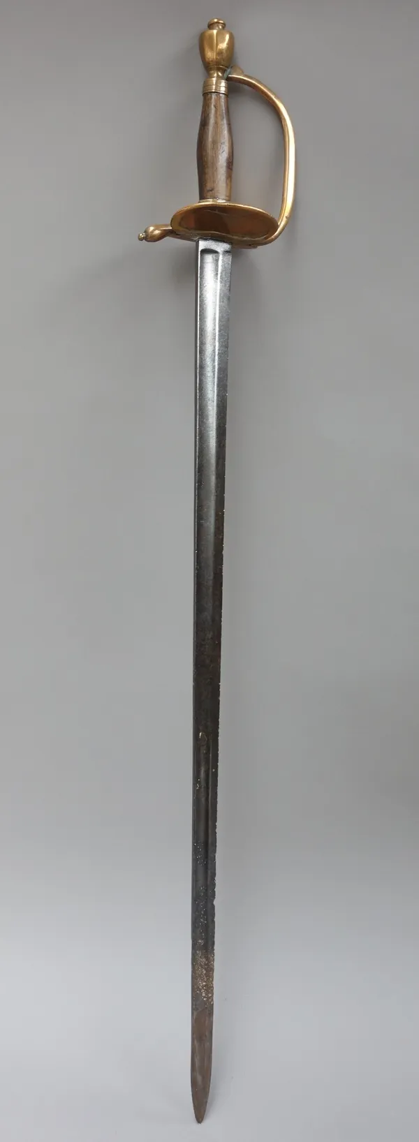 Two continental court swords, 19th century, each with straight steel blades, brass guard and wooden grips (91cm) and an African tribal knife. (3)