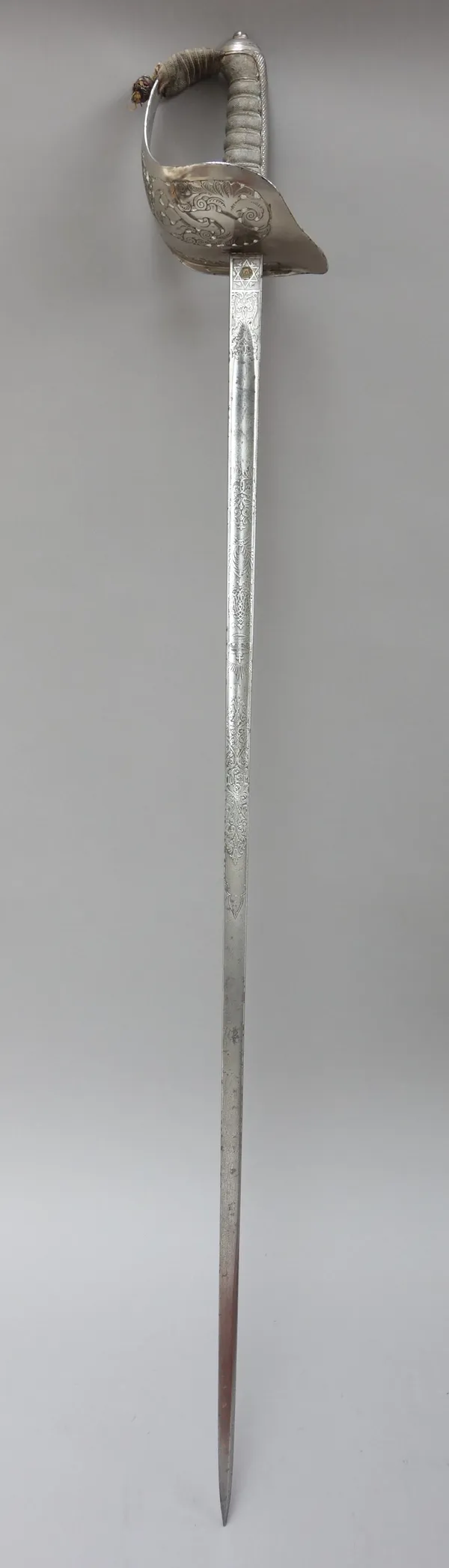 A Victorian officer's dress sword by 'E. THURKLE', 5 DENMARK St, SOHO, LONDON' with engraved straight blade (84cm), pierced steel hilt with 'VR' cyphe