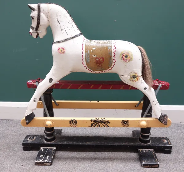 An early 20th century child's wooden rocking horse, polychrome painted on a swing frame base. (a.f.) 85cm high.