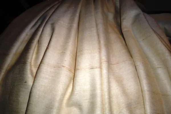 Curtains, comprising; a pair of cream raw silk lined and interlined curtains, each 140cm wide x 220cm fall. M9