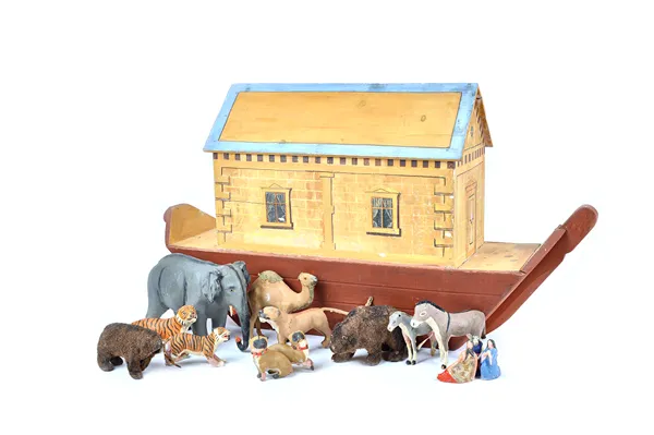 An early 20th century polychrome painted wooden Noah's Ark, 80cm wide, with later composite and elastolin animals, together with a wooden puzzle, (a.f