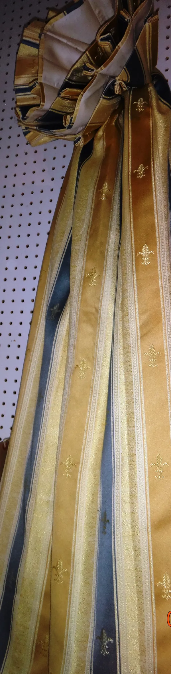 Curtains, comprising; a pair of gold and blue striped curtains with Fleur-de-lys and triple pleats, lined, each 178cm wide x 142cm fall.   M9
