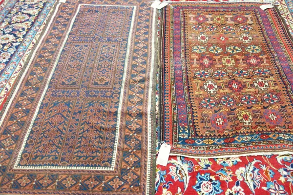A Beluchistan rug, the indigo field with six compartments, all with motifs and flower border, and a Garabagh rug, Caucasian, the madder field with row