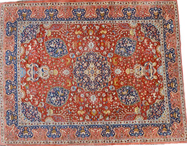 A large Tabriz carpet, the central deep blue stepped circular medallion with animals and birds, a floral decorated brick red main field, large border