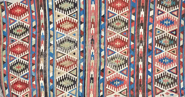 A Shiraz gelim, Persian, with polychrome banded design of single spiked medallions, 285cm x 156cm. Illustrated
