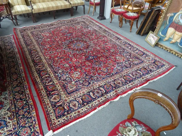 A Sarough carpet, Persian, the madder field with a large faceted medallion, indigo spandrels, all with intricate floral vine sprays, a dark indigo pal