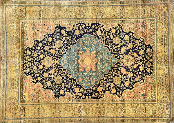 A Kashan Mohtashem rug, Persian, the dark indigo field with a pale indigo medallion, all with delicate floral sprays, an ivory flower border, 187cm x