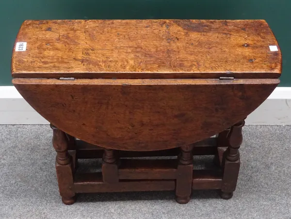 A diminutive 17th century style oak drop flap table, on baluster turned supports, 60cm wide x 50cm high, together with another similar, 60cm wide x 48