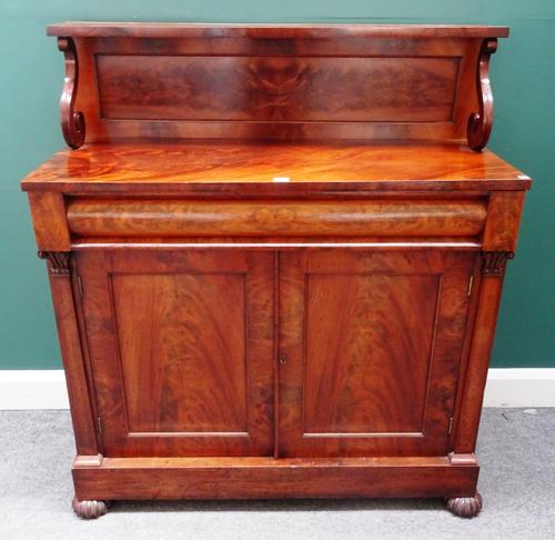 A William IV mahogany chiffonier, with ledge back over cushion drawer and pair of cupboards, on melon carved feet, 108cm wide 122cm high x 44cm deep.