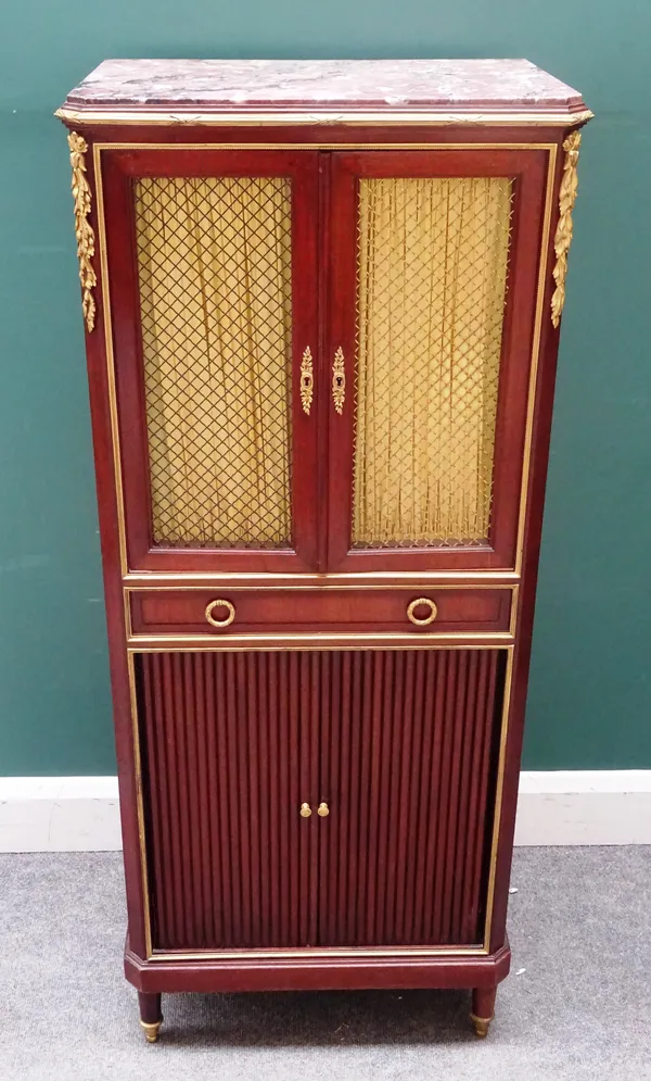 A Louis XVI style gilt metal mounted mahogany side cabinet, the marble top over a pair of grille doors, single drawer and tambour panel, on tapering t