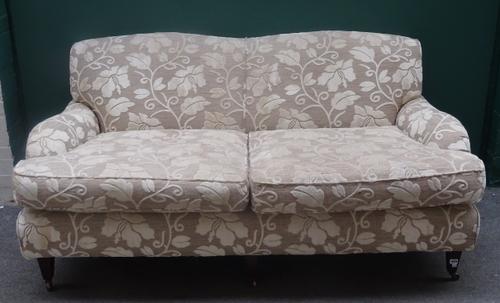 Wesley Barrell; a 20th century twin tone floral upholstered double hump back sofa, on tapering square supports, 185cm wide x 86cm high.
