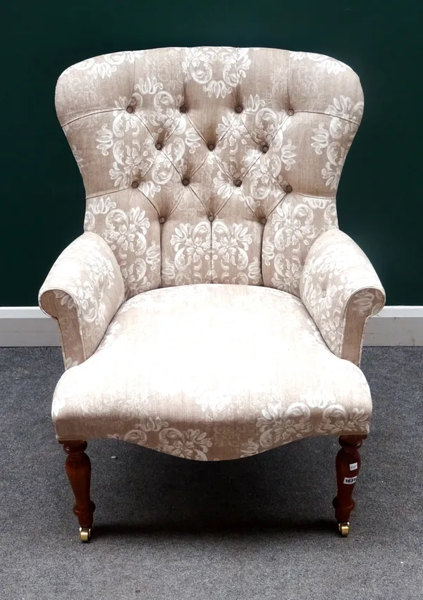 A Victorian style button back easy armchair, on turned stained beech supports, 77cm wide x 96cm high.