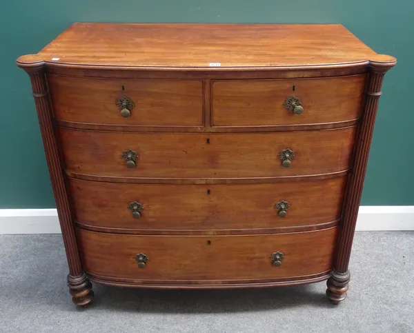 A Regency mahogany bowfront chest of two short and three long graduated drawers, flanked by reeded columns, 117cm wide x 105cm high x 58cm deep.