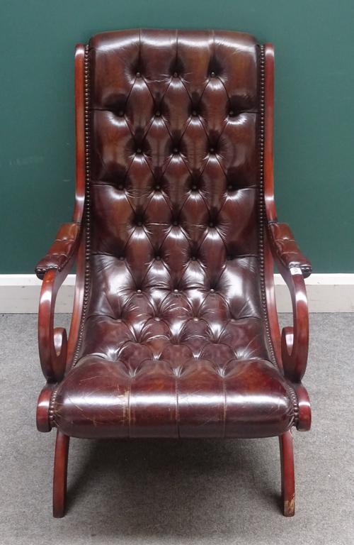 A Regency style slipper back library easy chair, with studded brown leather upholstery and open shepherd's crook arms, on 'X' framed base, 63cm wide x