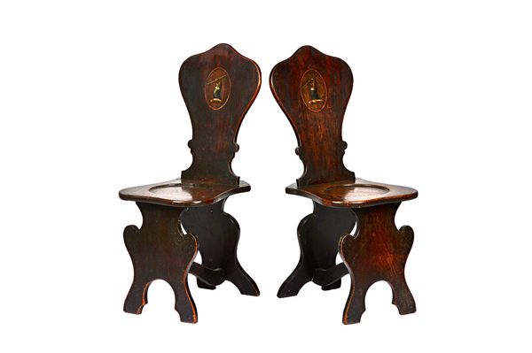 A pair of George II mahogany hall chairs, each with silhouette back and supports with dished circular seat, 38cm wide x 95cm high, (2). Illustrated