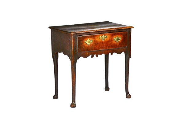 A mid-18th century oak lowboy, the rectangular top over single drawer and shaped frieze, on club supports, 71cm wide x 73cm high x 44cm deep. Illustra