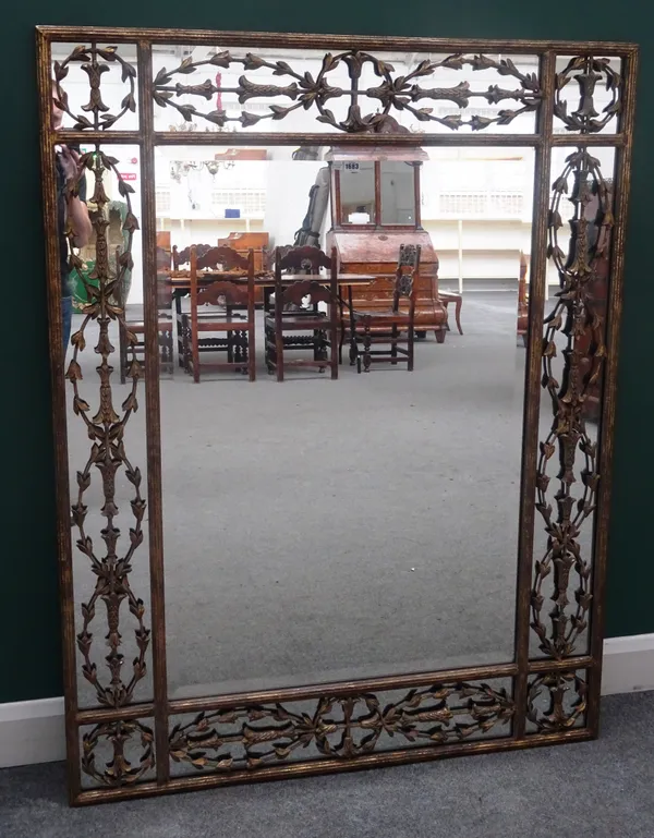 A 20th century gold painted rectangular mirror, with floral domed marginal frame, 117cm wide x 152cm high.