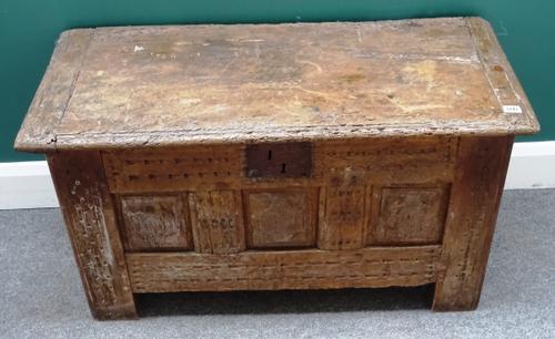 A 17th century and later oak coffer, the cleated slab top over triple panel fret front, on stile feet, 94cm wide x 55cm high x 43cm deep.