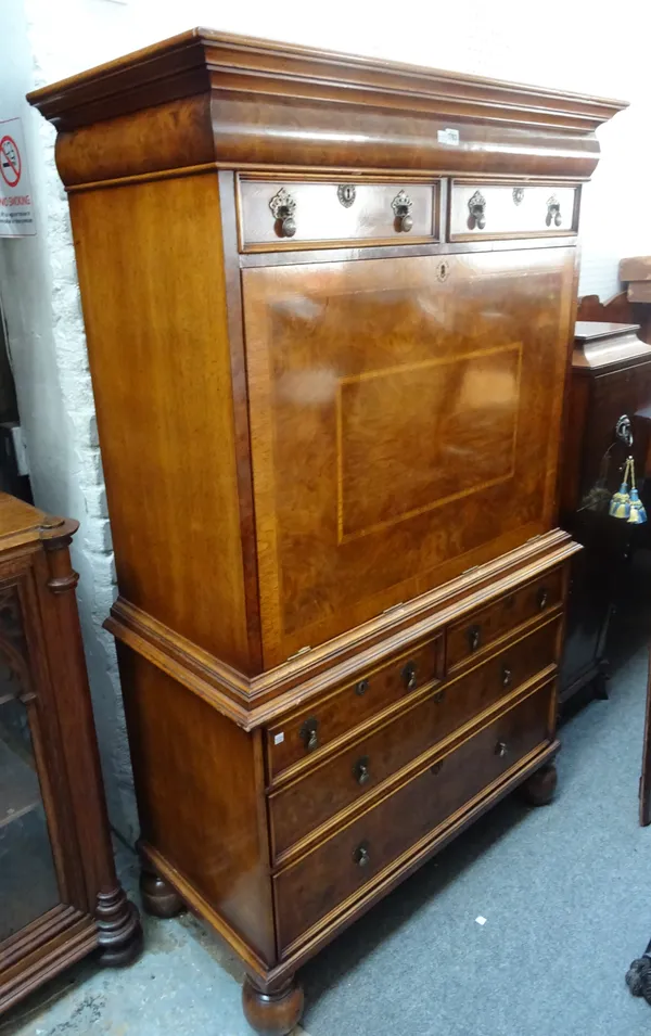 A Queen Anne style featherbanded walnut escritoire, with pair of short drawers over fall front revealing a fitted interior, above two further short an