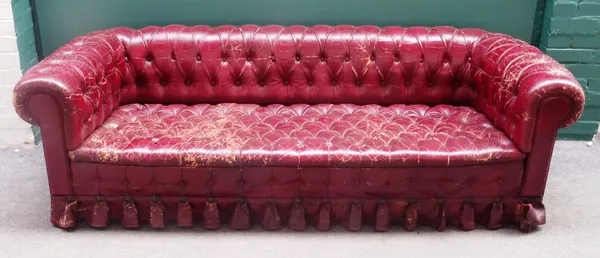 A 20th century button rouge leather upholstered Chesterfield sofa, 210cm wide x 63cm high, together with two matching armchairs, each 98cm wide x 63cm