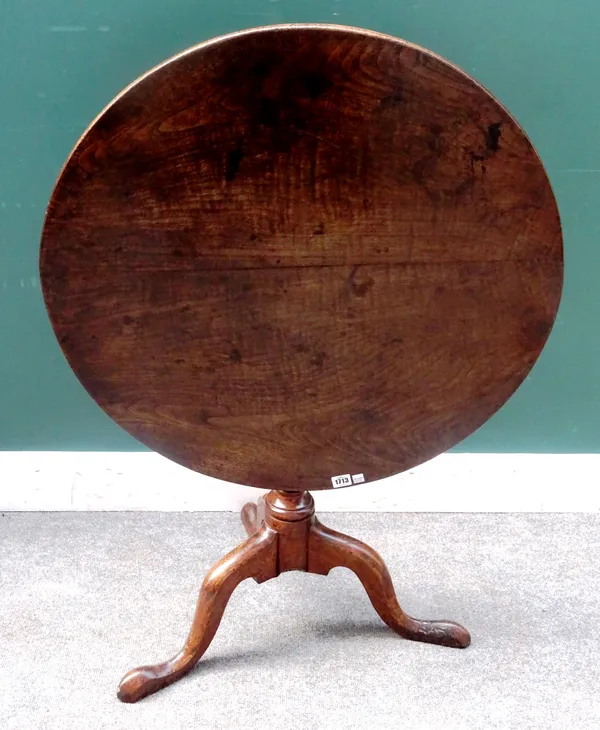 A mid-18th century oak and elm occasional table, the circular snap top on a tripod base, 78cm diameter x 68cm high.