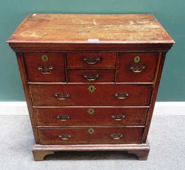 An early 18th century oak chest of four short and three long drawers, on bracket feet, 81cm wide x 92cm high x 46cm deep.