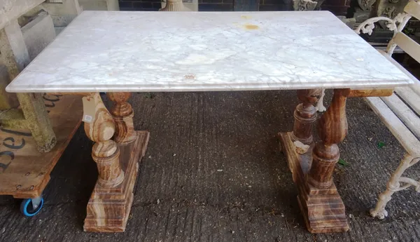 A marble centre table, the rectangular grey veined white marble top on a pair of double baluster trestle supports, 130cm wide x 80cm deep x 77cm high.
