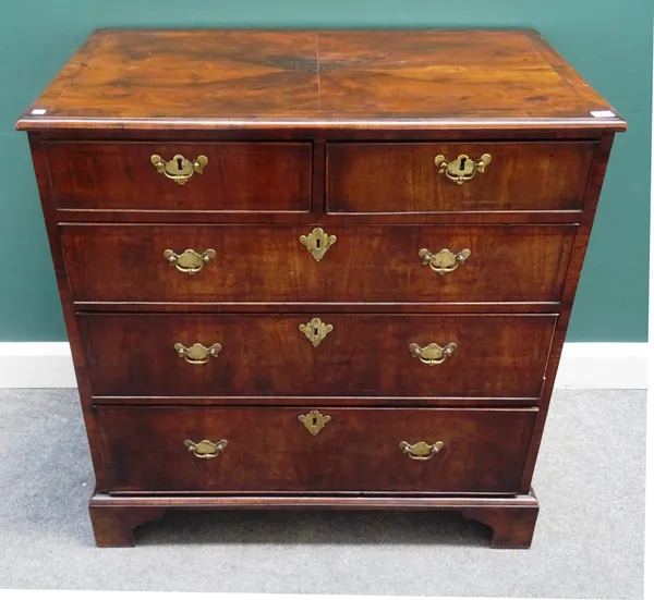An early 18th century and later figured walnut chest of two short and three long graduated drawers, on bracket feet, 94cm wide x 97cm high x 56cm deep