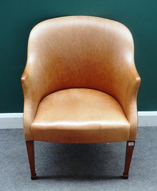 A mid-18th century style tub back office chair, in tan leather upholstery, on tapering square mahogany supports, 73cm wide x 94cm high.
