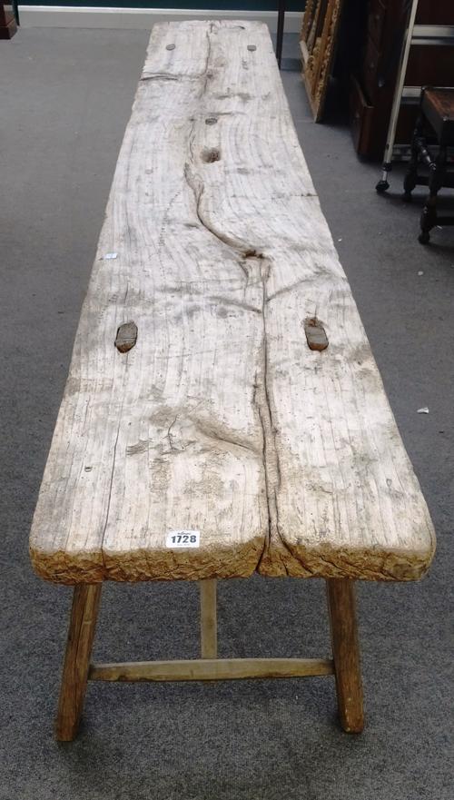 A rustic console table, the single slab rectangular driftwood top on four staked supports, 267cm wide x 77cm high x 39cm deep.