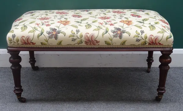 A rectangular oak framed footstool, with serpentine short ends, on 19th century fluted supports, 99cm long x 49cm wide x 47cm high.