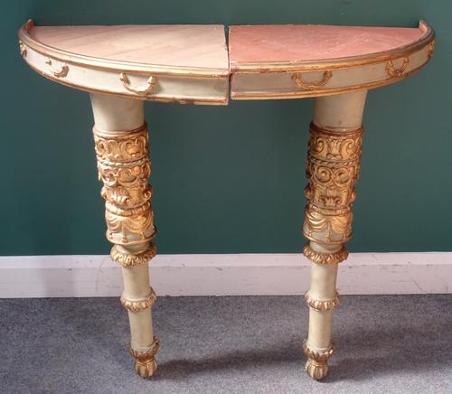 A pair of North Italian corner consoles, each on a carved and parcel gilt column, 66cm wide x 90cm high, (2).