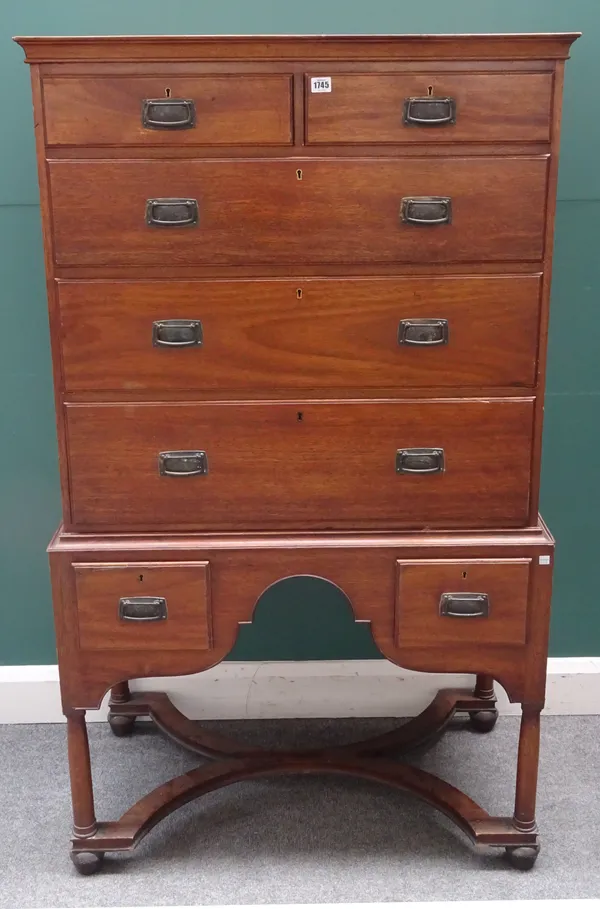 Heal & Son, Tottenham Court Road, London W1; a mid-20th century mahogany chest on stand, with two short over three long graduated drawers, the stand w
