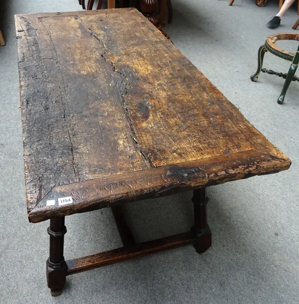 After A.W.N Pugin; a Victorian oak Gothic Revival centre table, with cleated single slab rectangular top, on four splayed octagonal supports united by