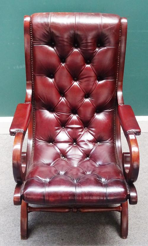 A Regency style slipper back library easy chair, with studded brown leather upholstery and open shepherd's crook arms, on 'X' framed base, 63cm wide x