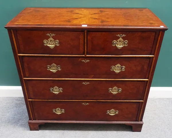 An early 18th century style figured walnut chest of two short and three long graduated drawers, on bracket feet, 104cm wide x 99cm high x 50cm deep.
