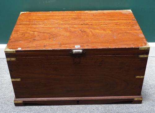 A 19th century brass bound rectangular teak trunk, with side carry handles, on a plinth base, 94cm wide x 48cm high x 63cm deep.